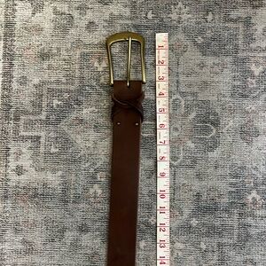 Brown leather belt with brass buckle